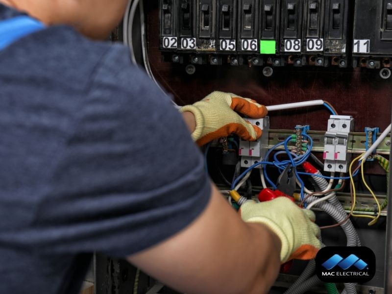 industrial electrician fixing electric cabinet